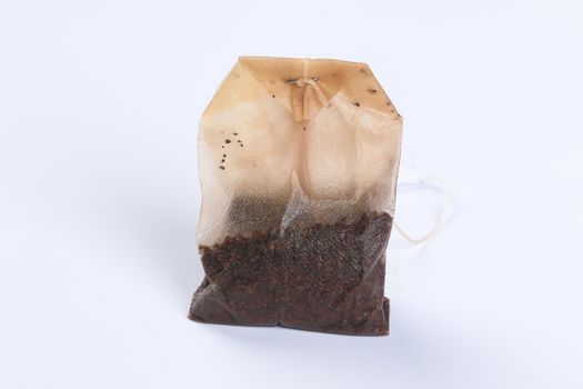 Used wet tea bag on a white background