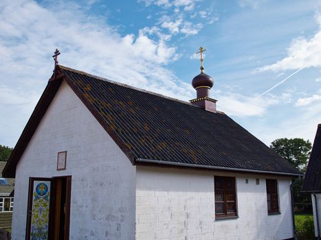 Small decorated Russian church with onion dome in a country village