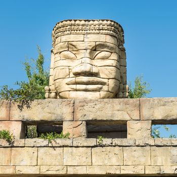 Stone face of a temple in the forest.