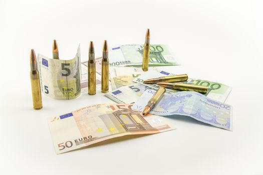 Composition with bullets and banknotes on white background.