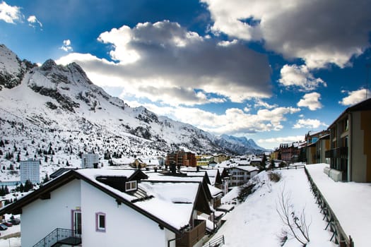 Alpine pass village covered by snow in winter.