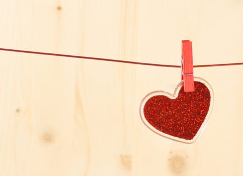 valentine day series, decorative red heart hanging on wood background with space for text