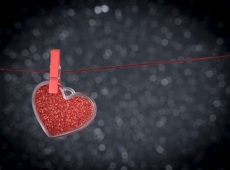 decorative red heart hanging against dark light bokeh background with space for text, concept of valentine day