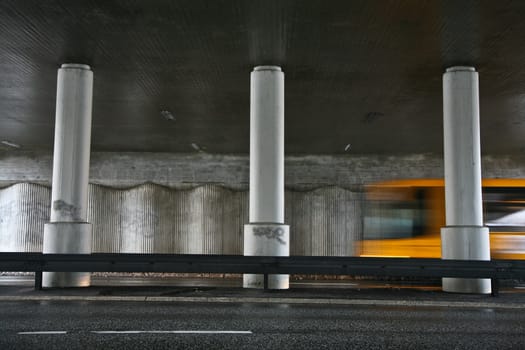 Traffic under the bridge and fast vehicles passing by