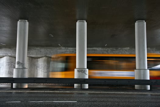Traffic under the bridge and fast vehicles passing by