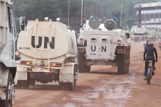 CENTRAL AFRICAN REPUBLIC, Bangui : Vehicles of the United Nations Multidimensional Stabilization Mission in Central African Republic, Minusca, passe on a street in Bangui, as it patrols in the city, on October 8, 2015. The Central African Republic descended into bloodshed more than two years ago after long time president Francois Bozize, a Christian, was ousted by Seleka rebels, triggering the worst crisis since independence in 1960. On September 29, 2015, Bangui returned to only relative calm after three days of inter-community violence which left at least 40 dead and 100 injured according to the UN Refugee Agency UNHCR. Some 27,000 inhabitants of Bangui have also fled to displaced people's camps. 