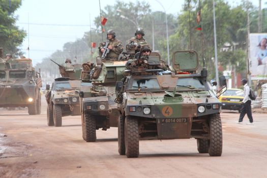 CENTRAL AFRICAN REPUBLIC, Bangui : Vehicles of the French Sangaris armed force passe on a street in Bangui, as it patrols in the city, on October 8, 2015. The Central African Republic descended into bloodshed more than two years ago after long time president Francois Bozize, a Christian, was ousted by Seleka rebels, triggering the worst crisis since independence in 1960. On September 29, 2015, Bangui returned to only relative calm after three days of inter-community violence which left at least 40 dead and 100 injured according to the UN Refugee Agency UNHCR. Some 27,000 inhabitants of Bangui have also fled to displaced people's camps. 