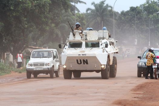 CENTRAL AFRICAN REPUBLIC, Bangui : Vehicles of the United Nations Multidimensional Stabilization Mission in Central African Republic, Minusca, passe on a street in Bangui, as it patrols in the city, on October 8, 2015. The Central African Republic descended into bloodshed more than two years ago after long time president Francois Bozize, a Christian, was ousted by Seleka rebels, triggering the worst crisis since independence in 1960. On September 29, 2015, Bangui returned to only relative calm after three days of inter-community violence which left at least 40 dead and 100 injured according to the UN Refugee Agency UNHCR. Some 27,000 inhabitants of Bangui have also fled to displaced people's camps. 