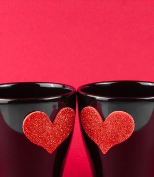 valentine day series, detail of cups of milk with decorative heart on red background with space for text