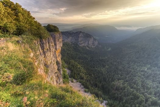 Creux-du-Van or Creux du Van rocky cirque at sunrise, Neuchatel canton, Switzerland