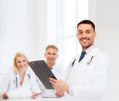 medicine, profession, and healthcare concept - smiling male doctor with clipboard and stethoscope writing prescription over white background