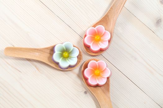 Thailand tradition ,Flower Dessert Coconut Jelly on wood 
spoon 