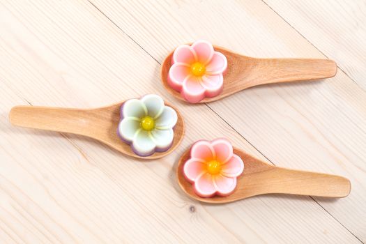 Thailand tradition ,Flower Dessert Coconut Jelly on wood 
spoon 