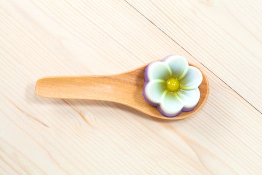 Thailand tradition ,Flower Dessert Coconut Jelly on wood 
spoon 