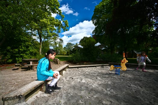 Girl on a playfield in Denmark in the sun