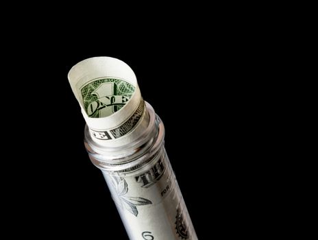 dollar banknote in graduated test tube, the cost of medical health on a black background