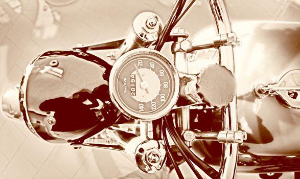 speedometer of a vintage golden motorcycle