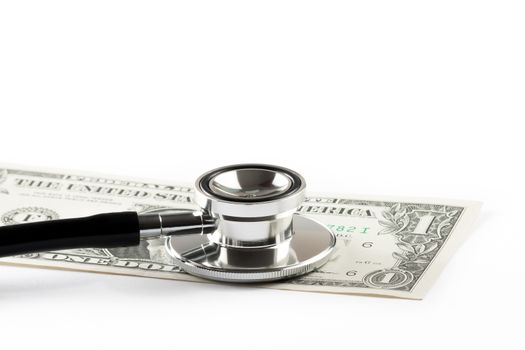stethoscope on one dollar under white background with space for text, cost of medical health care