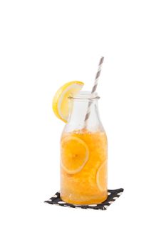 Iced lemon tea garnished with lemon in glass bottle isolated on white background with clipping path
