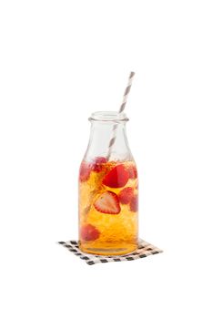 Iced strawberry tea in glass bottle with striped straw isolated on white background with clipping path