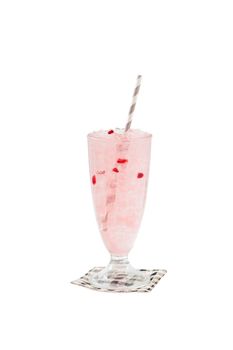 Iced lychee jelly with striped straw in glass garnished with red jelly isolated on white background with clipping path