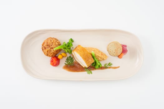 3 modern cuisine Prosciutto Wrapped Chicken with resotto and tamarind sauce, Fried mussaman curry, and Thai chicken spicy sausage on ceramic dish garnished with vegetables