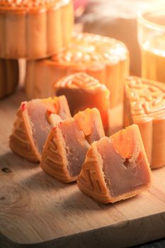 Moon cake, Chinese mid autumn festival dessert on wood board with dramatic morning scene