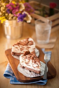 Chocolate cookie cheese cake on wood table with vintage scene in morning