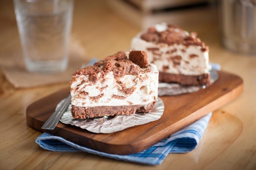 Chocolate cookie cheese cake on wood table with vintage scene in morning