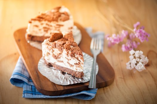 Chocolate cookie cheese cake on wood table with vintage scene in morning