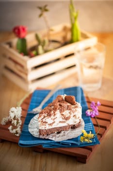 Chocolate cookie cheese cake on wood table with vintage scene in morning