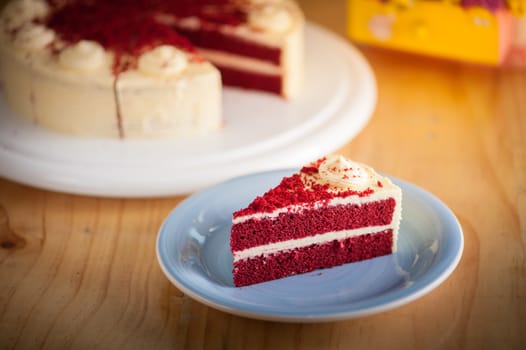 Red velvet cake on wood table with morning scene