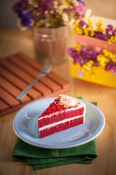 Red velvet cake on wood table with morning scene