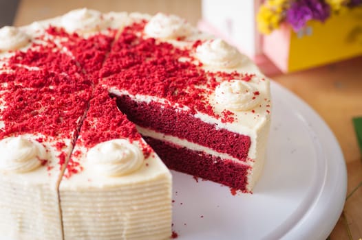 Red velvet cake on wood table with morning scene