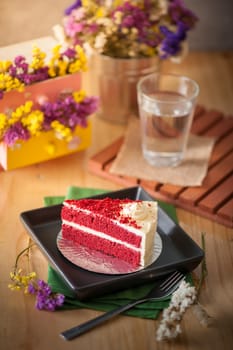 Red velvet cake on wood table with morning scene