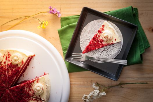 Red velvet cake on wood table with morning scene