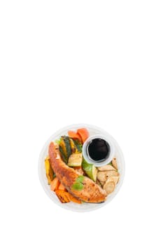 Salmon steak and grilled vegetables cooked by clean food concept with Japanese sesame soy sauce in lunch box isolated on white background