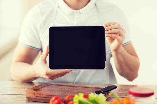 cooking, technology, advertising and home concept - close up of male hands holding tablet pc with blank black screen