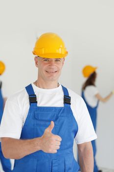 Manual worker with thumb up sign, Indoors