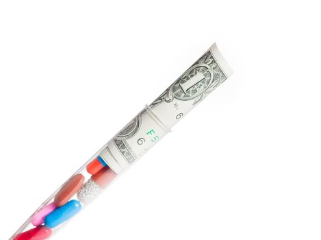 colorful pills and dollars in test tube, cost of medical health care on light white background