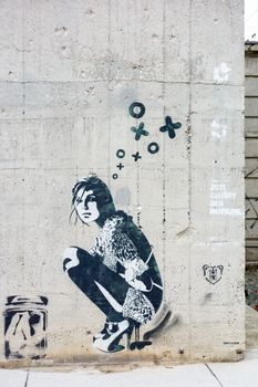 Berlin, Germany - October 26, 2013: Graffiti of a girl / woman on a concrete wall in Berlin.