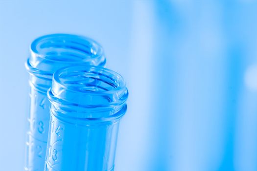 detail of the test tubes in laboratory on blue light tint background with space for text