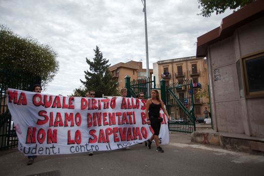 ITALY, Palermo: Thousands of students marched and held banners against Renzi's school reform in Palermo, Italy on October 9, 2015.A theme of the protests is the revisions to the calculation of family income, which some say will reduce scholarships and housing for students. Students throughout the country protested what's know as La Buona Scuola.  A spokesman for the protesters said they were going to announce a week of mobilization lasting until October 17. They plan to launch an attack for free education and reversal of policies. 