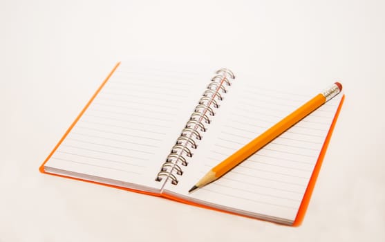 Notebook and pencil isolated on white background