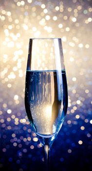 one flute of champagne on blue and white bokeh background