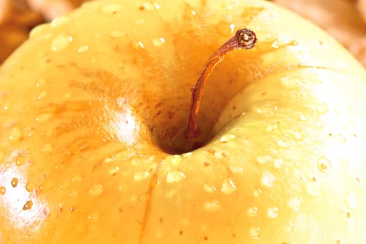 macro wet yellow delicious apple, diet concept