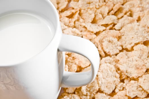 detail of milk on corn flakes background, breakfast concept