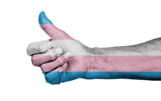 Old woman with arthritis giving the thumbs up sign, Trans Pride