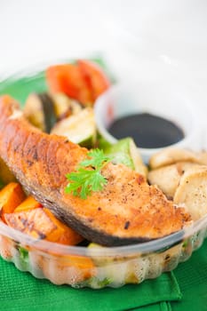 Salmon steak and grilled vegetables cooked by clean food concept with Japanese sesame soy sauce in lunch box