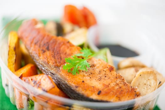 Salmon steak and grilled vegetables cooked by clean food concept with Japanese sesame soy sauce in lunch box